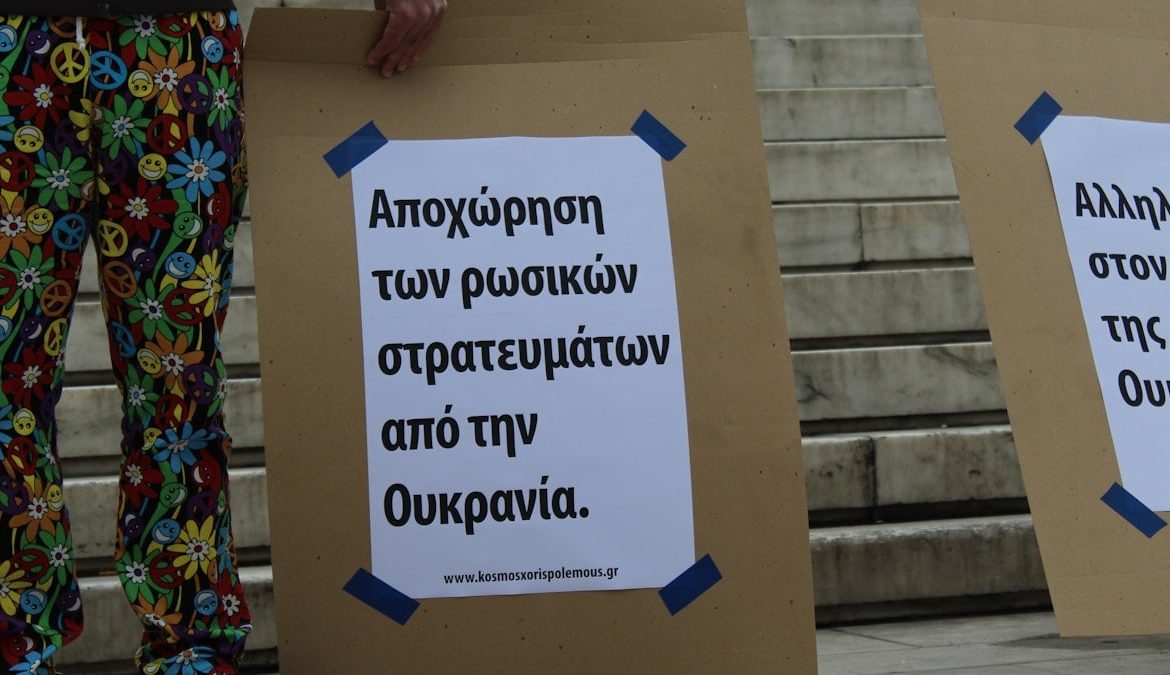 a couple of people standing next to each other holding signs